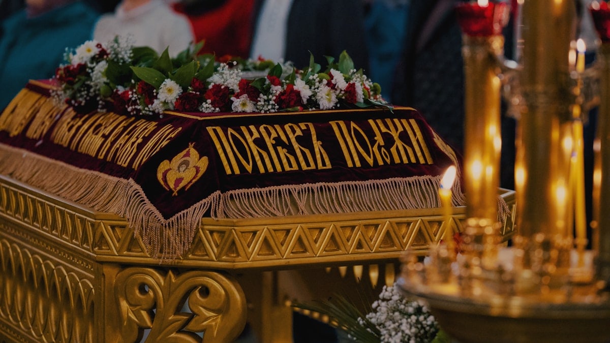 A decorated coffin is the focus of the ceremony.